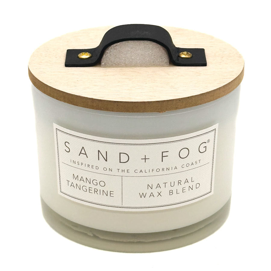 Mango Tangerine candle with wooden lid and Sand + Fog label on a white background