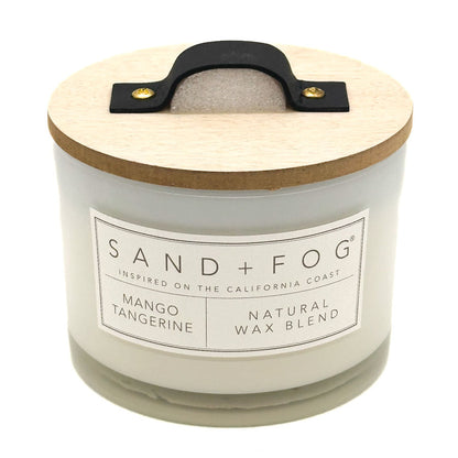 Mango Tangerine candle with wooden lid and Sand + Fog label on a white background