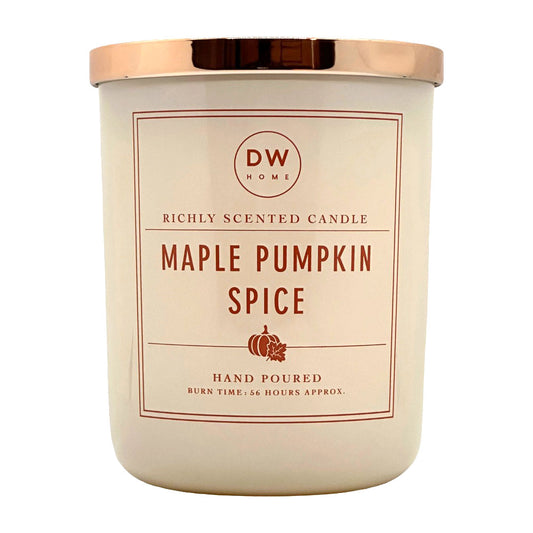 A beige glass jar candle with a metallic rose gold lid. The label features the brand 'DW HOME' and the scent name 'MAPLE PUMPKIN SPICE' in dark red letter.