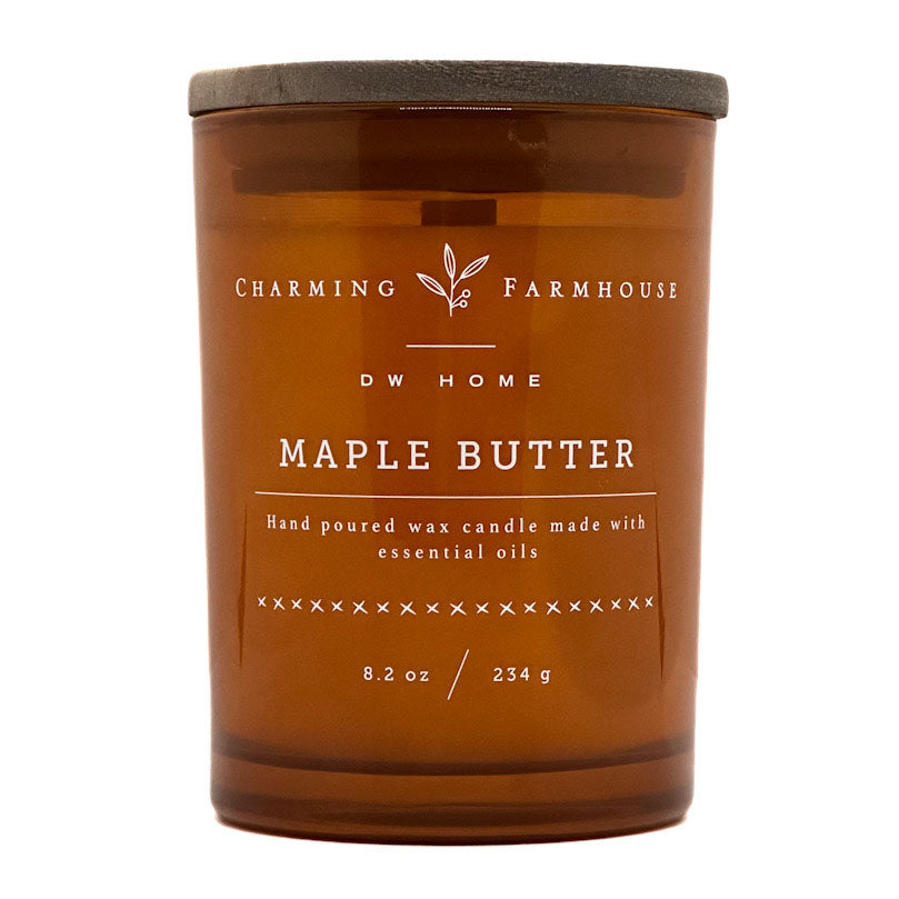An amber glass jar candle with a dark gray lid, labeled 'Charming Farmhouse DW Home Maple Butter' on a white background.