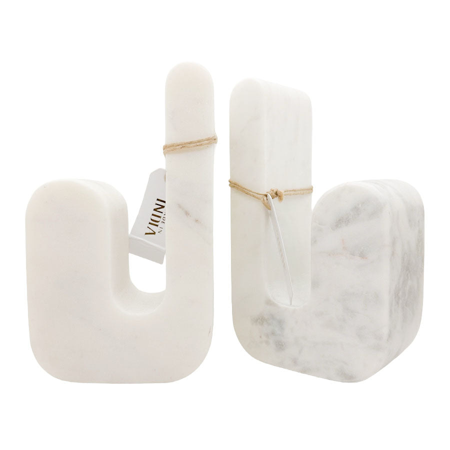 White marble bookends in the form of the letter 'J'