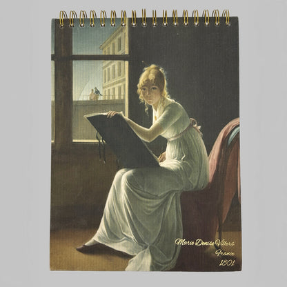 Notebook with a painting of a woman sitting by a window, holding a book, on the cover.