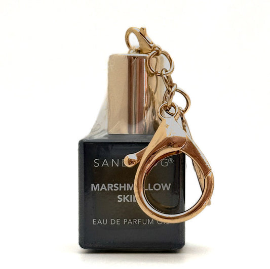 A miniature perfume bottle bag charm keychain with a dark charcoal gray bottle, a metallic gold cap, and a gold key ring attached by a short chain, shown on a white background.