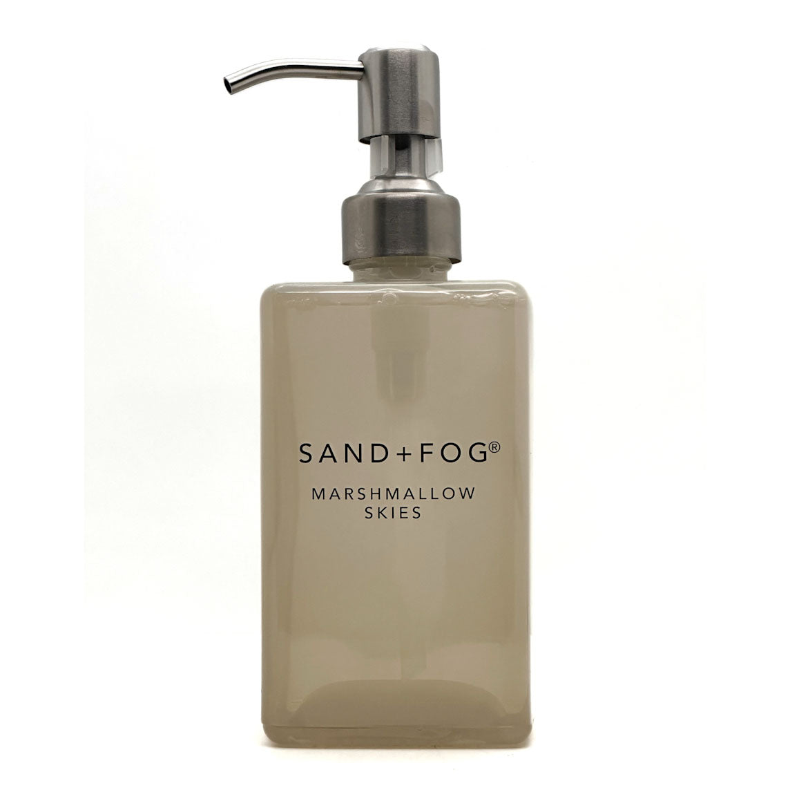 A frosted glass soap dispenser bottle in a warm beige-tinted shade with a brushed silver metal pump, featuring the text 'SAND+FOG MARSHMALLOW SKIES' on the front, set against a plain white background.