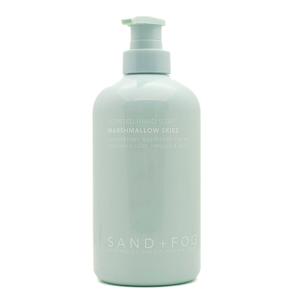 SAND + FOG Light blue bottle of Marshmallow Skies scented hand soap on a white background