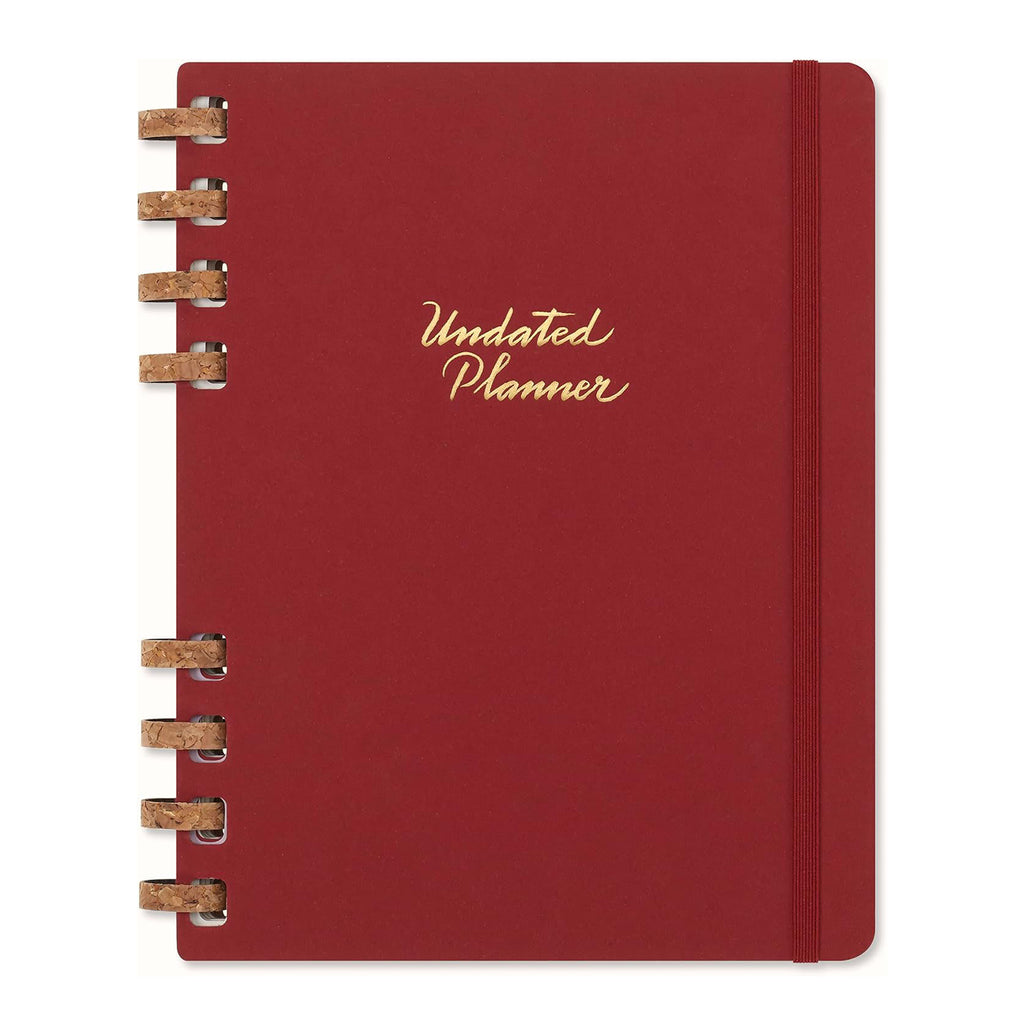Moleskine red planner with gold text on a white background.