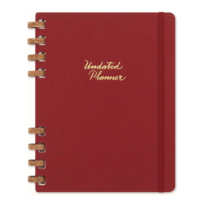 Moleskine red planner with gold text on a white background.