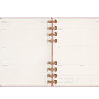 Open planner with weekly layout on white background