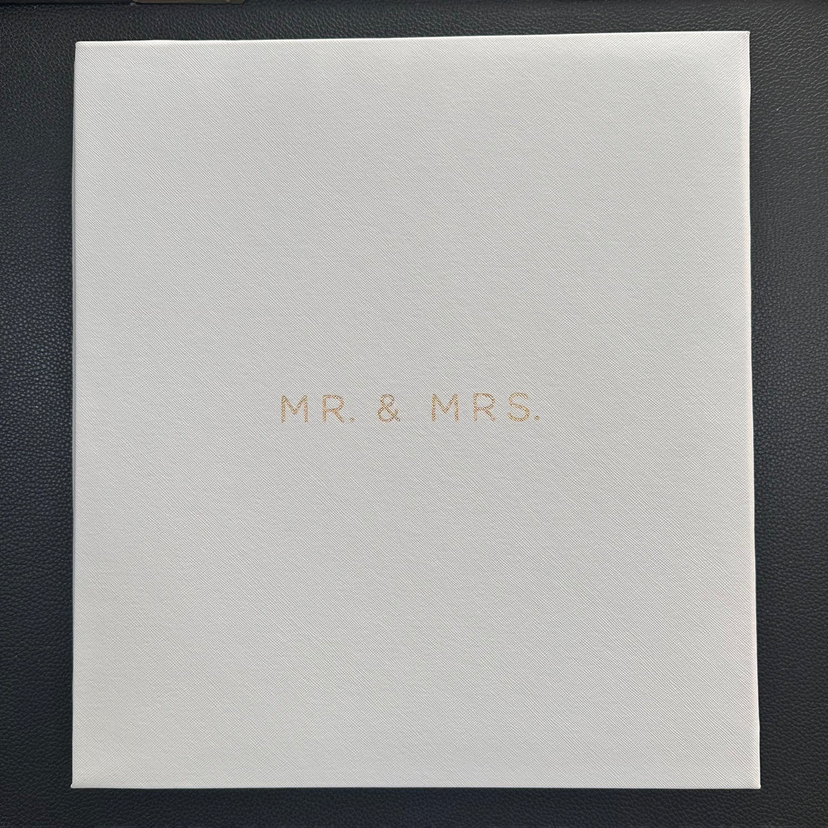 A square white textured photo album with the words 'MR. & MRS.