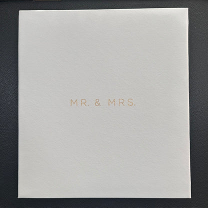 A square white textured photo album with the words 'MR. & MRS.