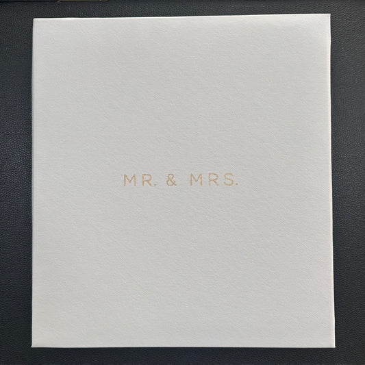 A square white textured photo album with the words 'MR. & MRS.