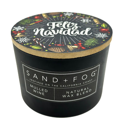Mulled Wine black candle with 'Feliz Navidad' lid featuring holiday designs, branded as Sand + Fog.
