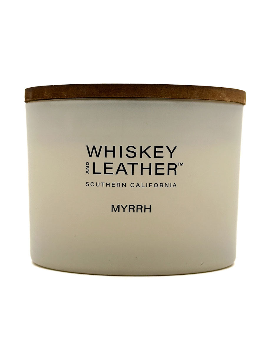 Myrrh candle with 'Whiskey and Leather' branding on a white background