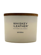Myrrh candle with 'Whiskey and Leather' branding on a white background