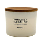 Myrrh scented candle with wooden lid labeled 'Whiskey and Leather' on a white background