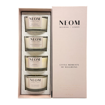 NEOM 'Little Moments of Wellbeing' gift set containing four scented candles in a light pink presentation box with a matching outer box cover.