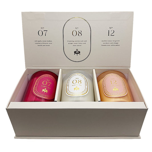 A boxed set of three Ninety Six by DW Home candles displayed in an open cream-coloured gift box. The candles are numbered 07, 08, and 12, with labels in pink, white, and peach tones.