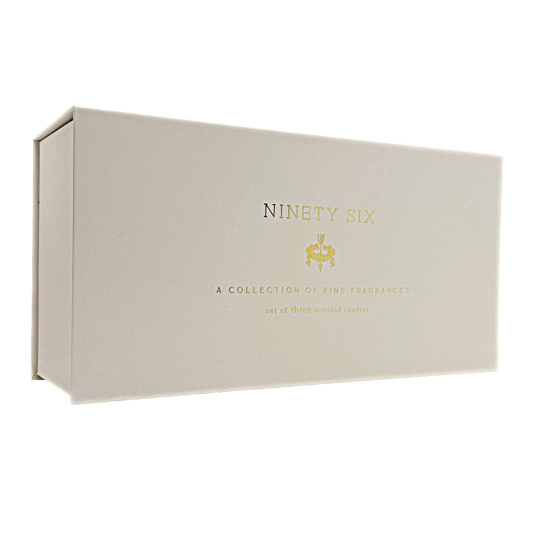 A cream-coloured rectangular candle gift box with gold foil text reading 'NINETY SIX' and smaller text below, photographed on a plain white background.