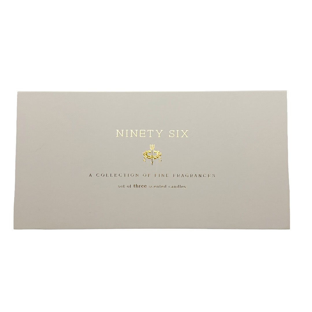 A rectangular beige candle gift box cover with gold foil text reading 'NINETY SIX' and smaller text below, photographed on a plain white background.