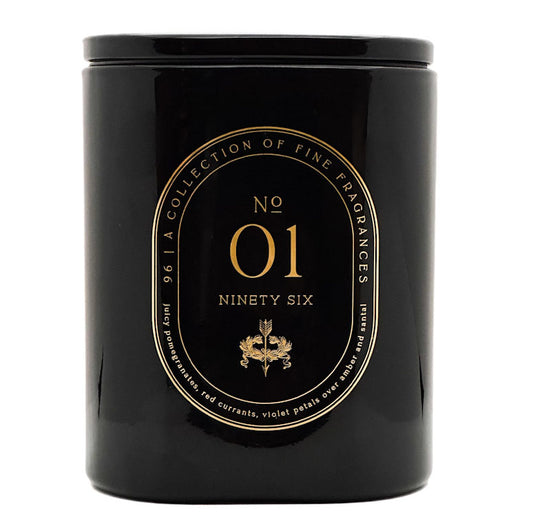 A black cylindrical scented candle jar with a glossy finish, featuring a gold circular label that reads 'No 01 Ninety Six' and 'A Collection of Fine Fragrances'.