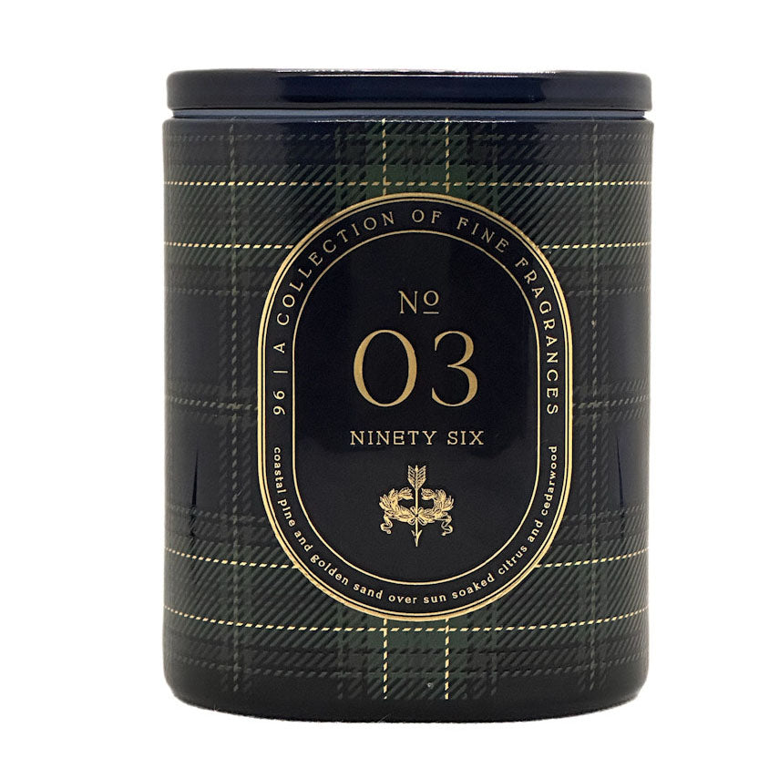 A cylindrical scented candle jar with a dark navy and black plaid pattern and gold lettering. The front label reads 'No 03 Ninety Six' and 'A Collection of Fine Fragrances'.