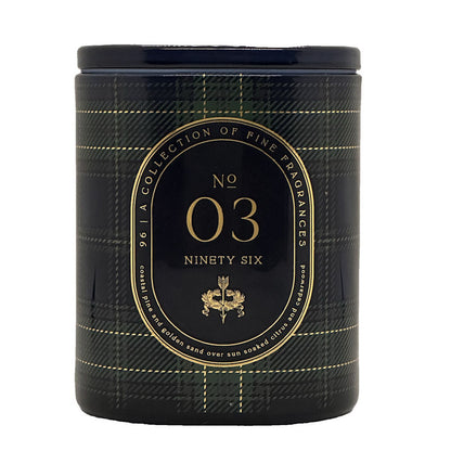 A cylindrical scented candle jar with a dark navy and green plaid pattern, featuring a central black label with gold lettering that reads 'No 03 Ninety Six' and 'A Collection of Fine Fragrances'.