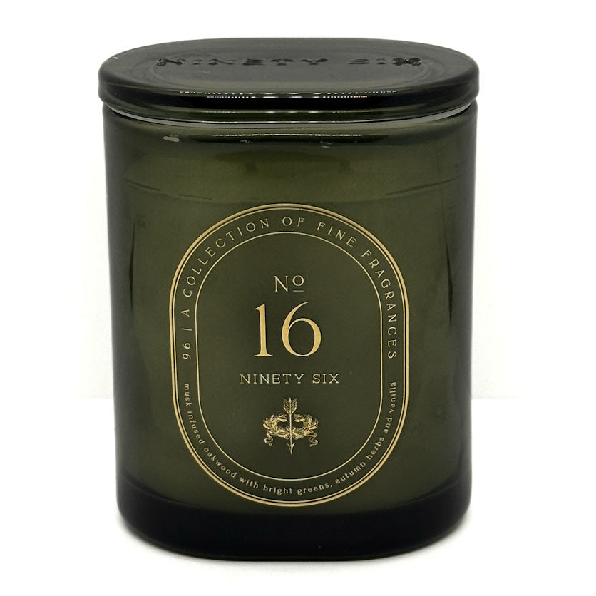An olive green glass jar candle with a lid and a gold circular label reading 'No. 16 Ninety Six' on a white background.