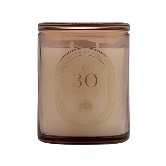 A No. 30 DW Home scented candle in a translucent amber glass jar with a cream-coloured wax and a gold-toned oval label on the front.