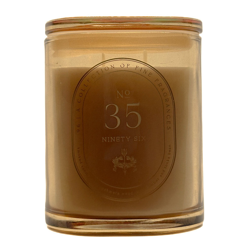 A 286g candle in a translucent amber glass jar with a matching glass lid, featuring a central oval label that reads 'No. 35 Ninety Six' and 'A Collection of Fine Fragrances'.