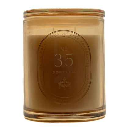 A 286g candle in a translucent amber glass jar with a matching glass lid, featuring a central oval label that reads 'No. 35 Ninety Six' and 'A Collection of Fine Fragrances'.