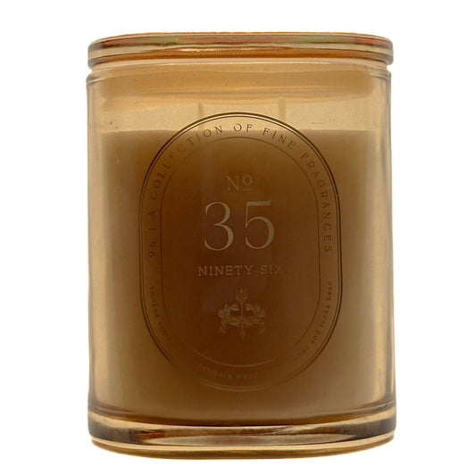 A 286g candle in a translucent amber glass jar with a matching glass lid, featuring a central oval label that reads 'No. 35 Ninety Six' and 'A Collection of Fine Fragrances'.