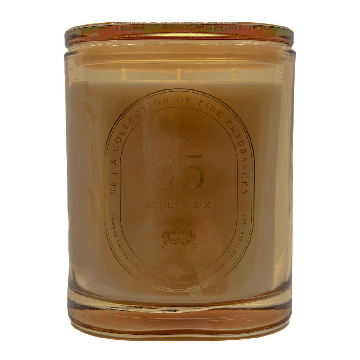 A No. 35 35 DW Home scented candle in a translucent amber glass jar with a gold-toned metal lid, featuring an embossed oval label on the front.