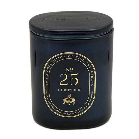 A dark navy blue glass jar candle with a matching lid, featuring a gold circular label that reads 'No. 25 Ninety Six' and 'A Collection of Fine Fragrances'.