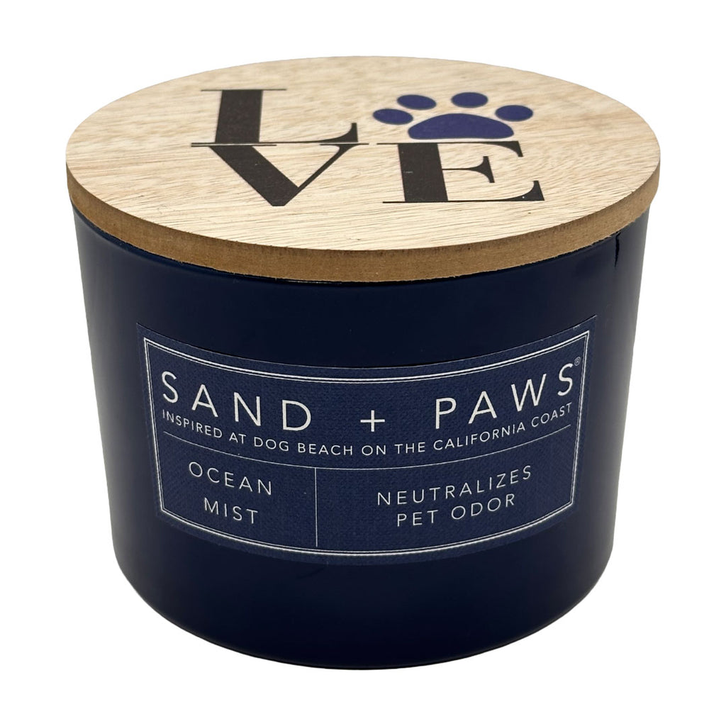 Ocean Mist candle container with wooden lid featuring 'SAND + PAWS' branding on a white background