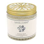 A jar of Sand + Paws Ocean Mist pet odor neutralizing gel beads with a gold metal lid and white label, set against a plain white background.