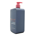 Blue body wash bottle with pink pump on a white background