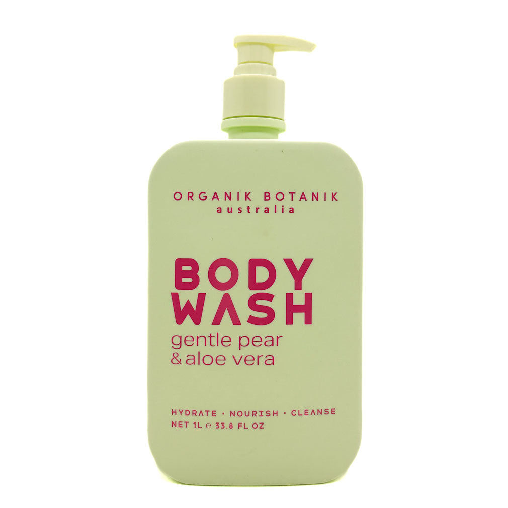 A bottle of Organik Botanik Body Wash in the Gentle Pear & Aloe Vera scent. The bottle is a pale, light green colour with a matching pump dispenser, featuring bold magenta text on the front label.