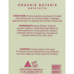 Back of a bottle of Organik Botanik Australia body wash, showing usage directions, ingredients list, warning, and a barcode on a pale beige background.