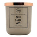 A candle jar with a matte taupe-gray body and a metallic rose gold lid, featuring a front label that reads 'DW HOME' and 'PALO SANTO'.