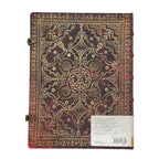 Decorative notebook with intricate gold patterns on a white background