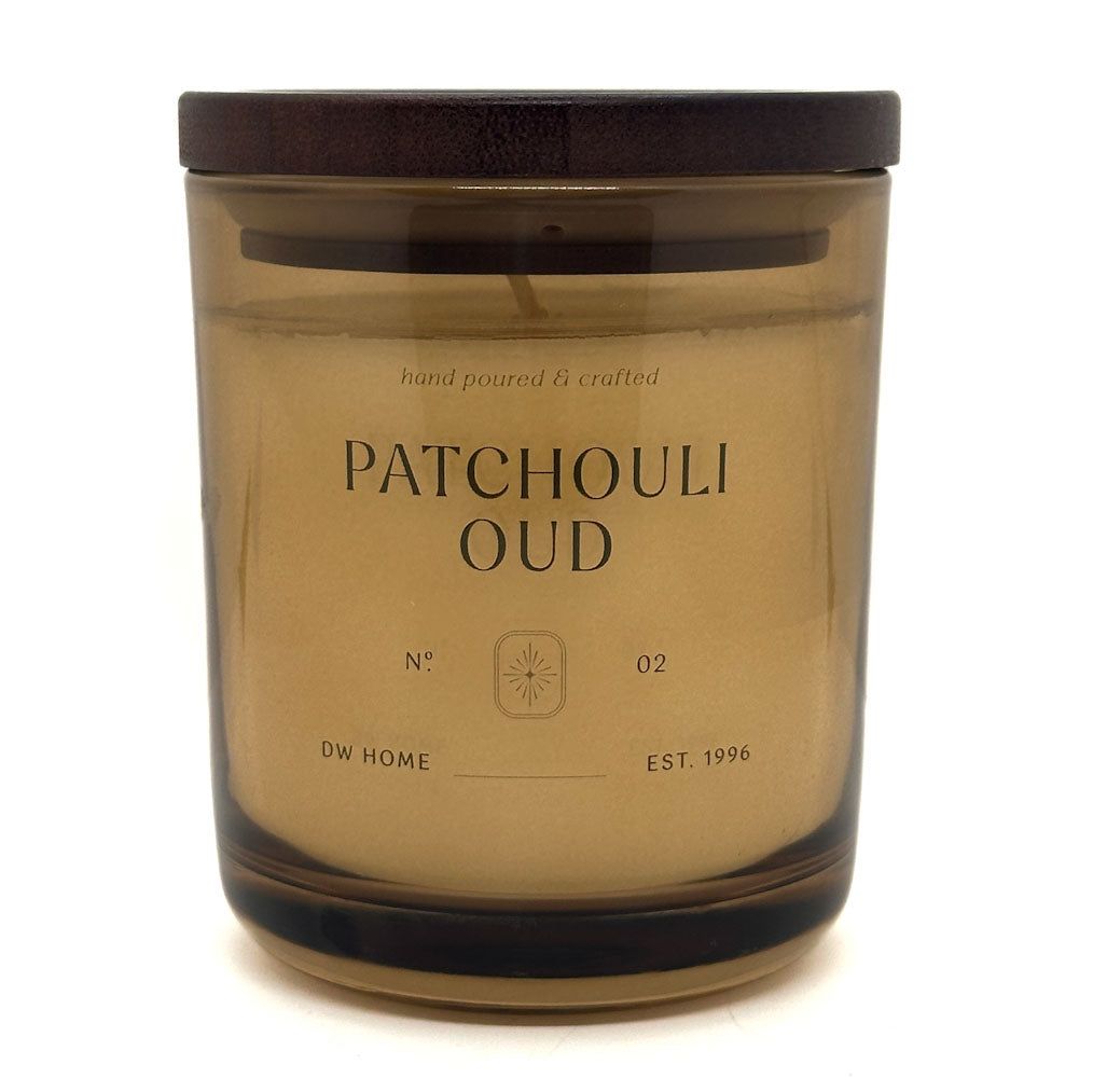 Patchouli Oud candle in a brown glass jar with a wooden lid on a white background