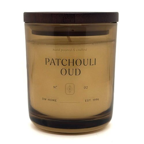 Patchouli Oud candle in a brown glass jar with a wooden lid on a white background
