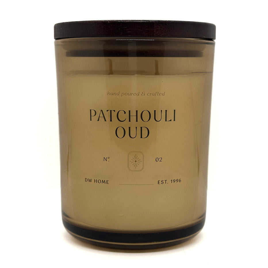 Candle jar labeled 'Patchouli Oud' by DW Home on a white background