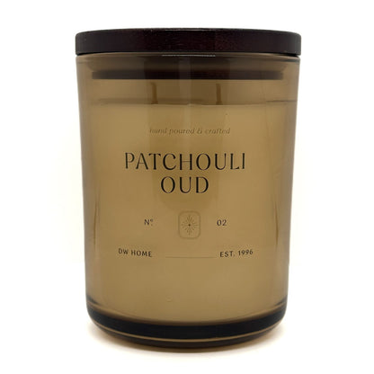 Candle jar labeled 'Patchouli Oud' by DW Home on a white background