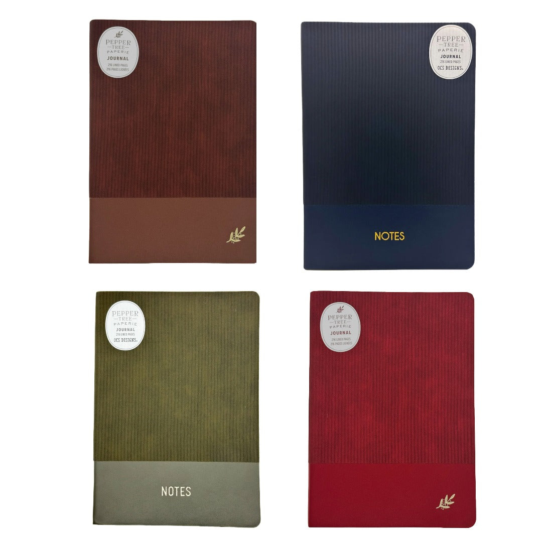 Four hardcover journal covers arranged in a 2x2 grid on a white background, each with a ribbed texture and a circular white sticker. The top-left is brown, the top-right is navy blue, the bottom-left is olive green, and the bottom-right is red.