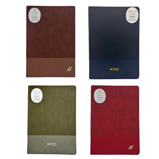 Four hardcover journal covers arranged in a 2x2 grid on a white background, each with a ribbed texture and a circular white sticker. The top-left is brown, the top-right is navy blue, the bottom-left is olive green, and the bottom-right is red.