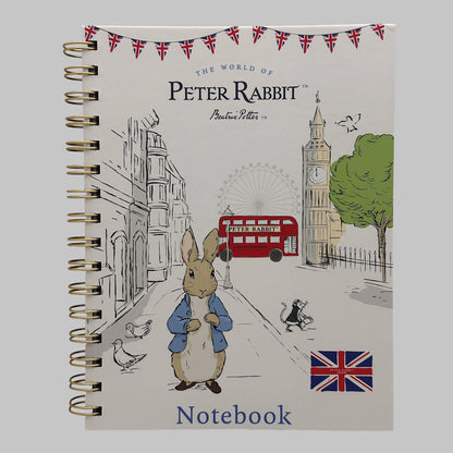 A spiral-bound notebook featuring the classic Peter Rabbit illustration on the cover, with the title 'The World of Peter Rabbit' and 'Notebook' visible. The cover shows Peter Rabbit in London with a red bus, Big Ben, and Union Jack accents.