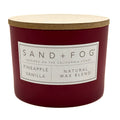 Pineapple vanilla Red candle with a wooden lid labeled 'Sand + Fog' on a white background