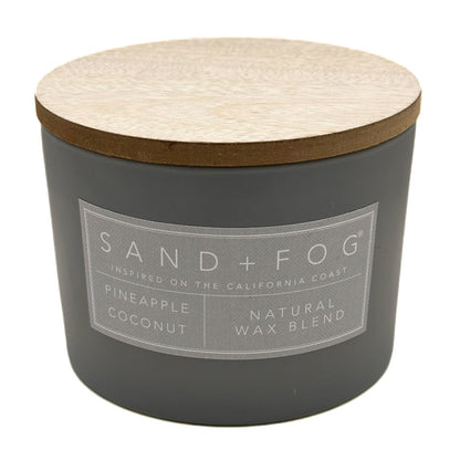 Pineapple Coconut Grey candle with wooden lid and 'Sand + Fog' label on a white background