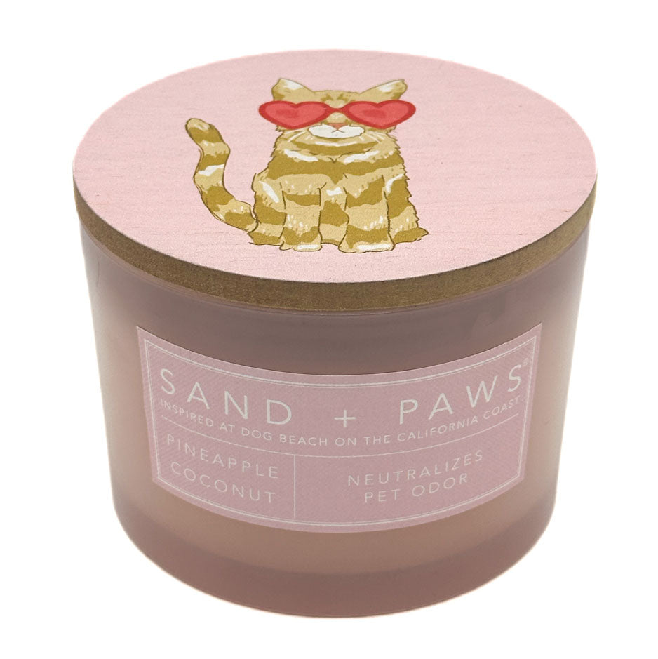 Pineapple Coconut candle in a pink jar with a cat on the lid, branded SAND + PAWS.